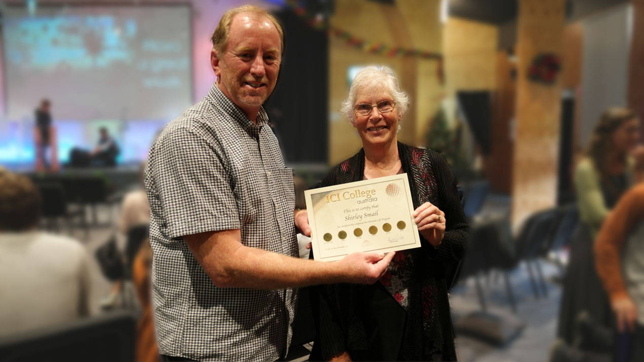 Dr. Andrew Corbett presenting an ICI College 'Christian Life Certificate' to a successful student who completed all 18 of the Christian Life subjects.